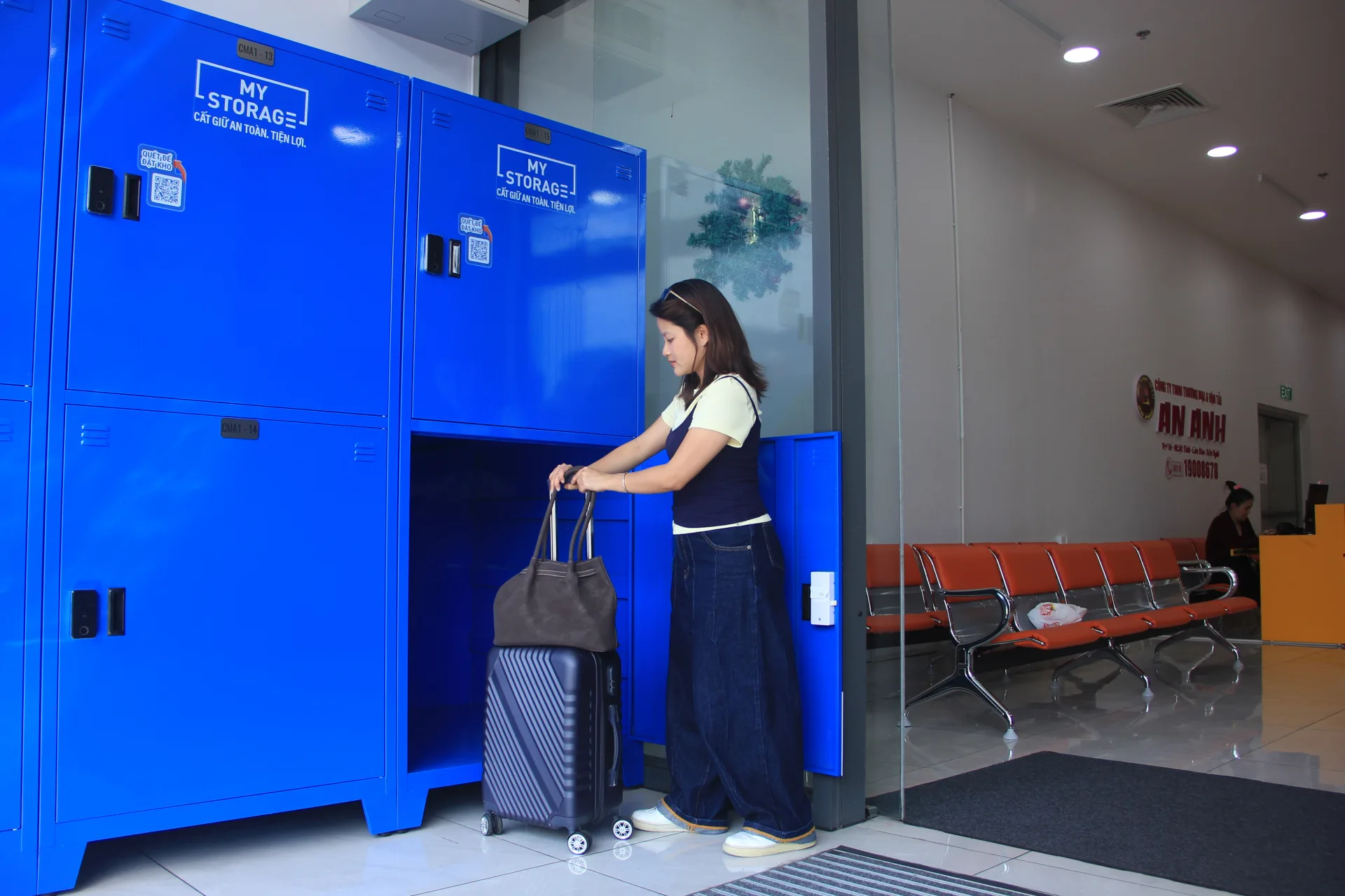 A customer placing a handbag into an open MyStorage locker at Centre Mall District 6