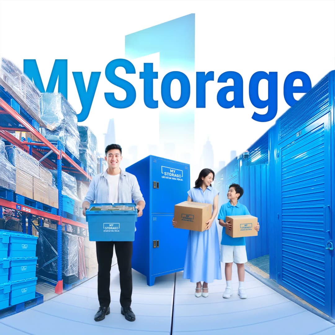 MyStorage staff and a family carrying storage boxes between blue lockers and warehouse shelves