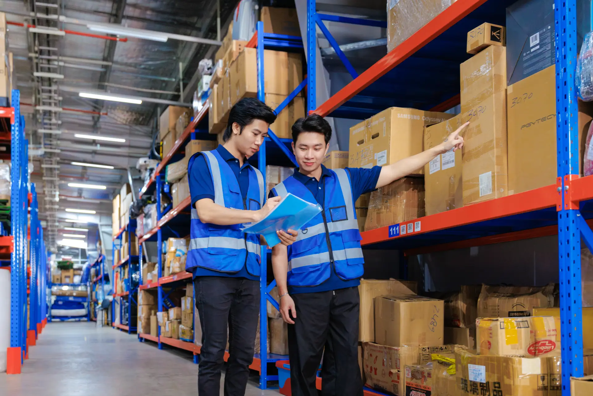 Two MyStorage warehouse staff handling valet storage items