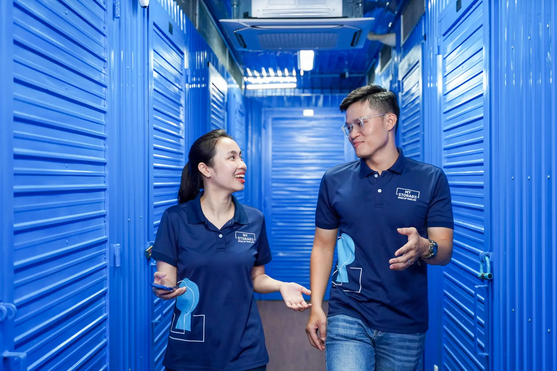 Two MyStorage team members walking through the storage facility