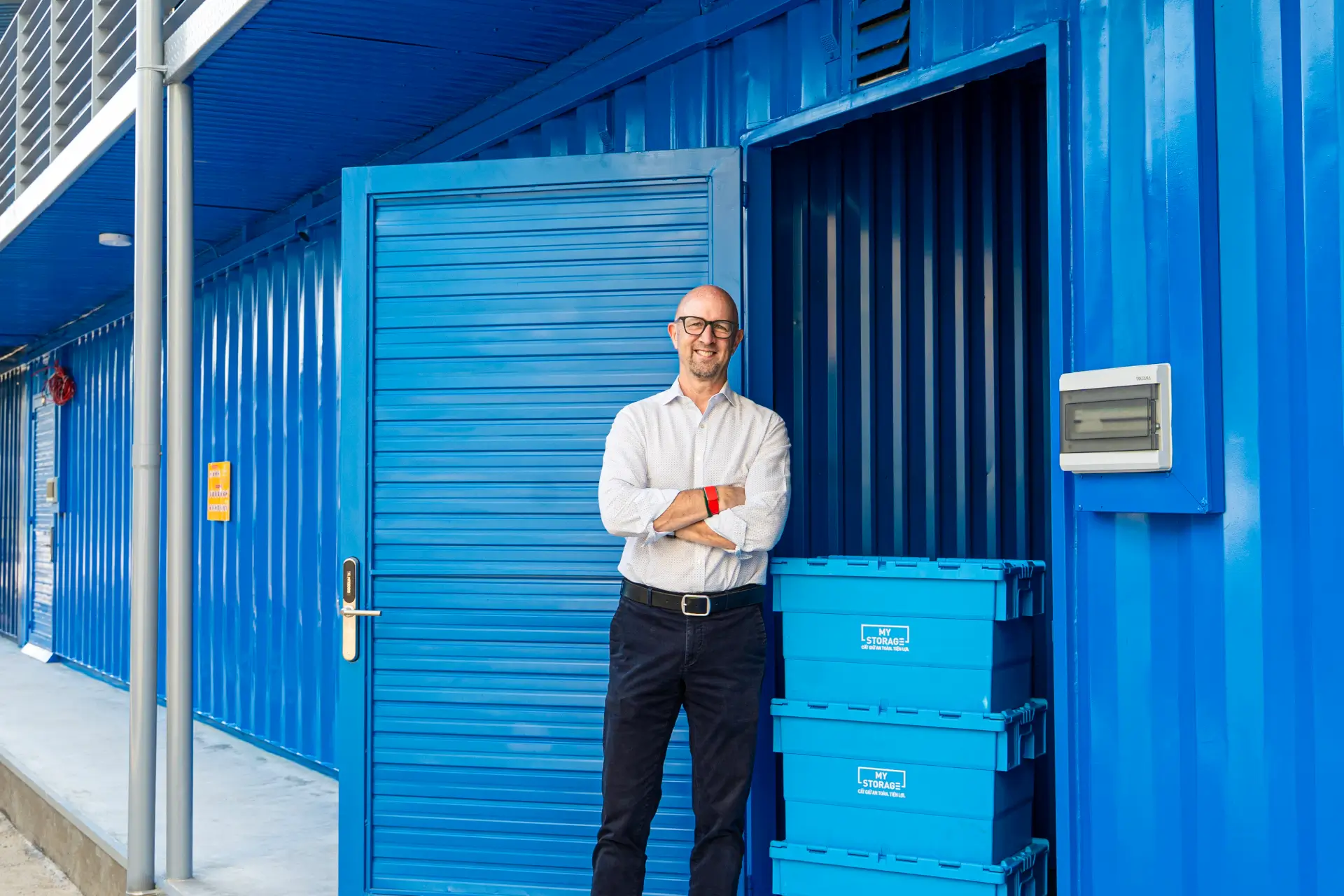 Man standing in front of a blue MyStorage storage container.