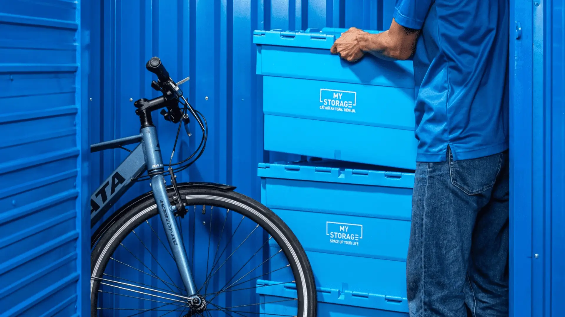 Man with bicycles at a MyStorage facility.