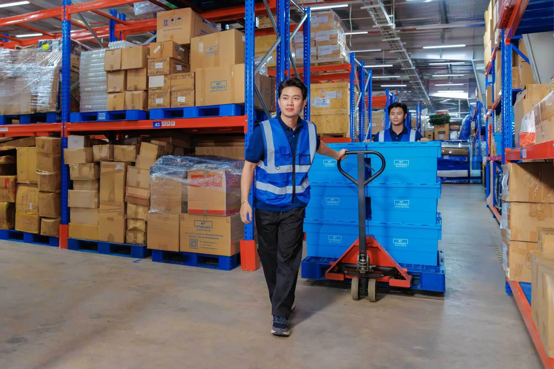 A warehouse worker in a MyStorage self storage aisle
